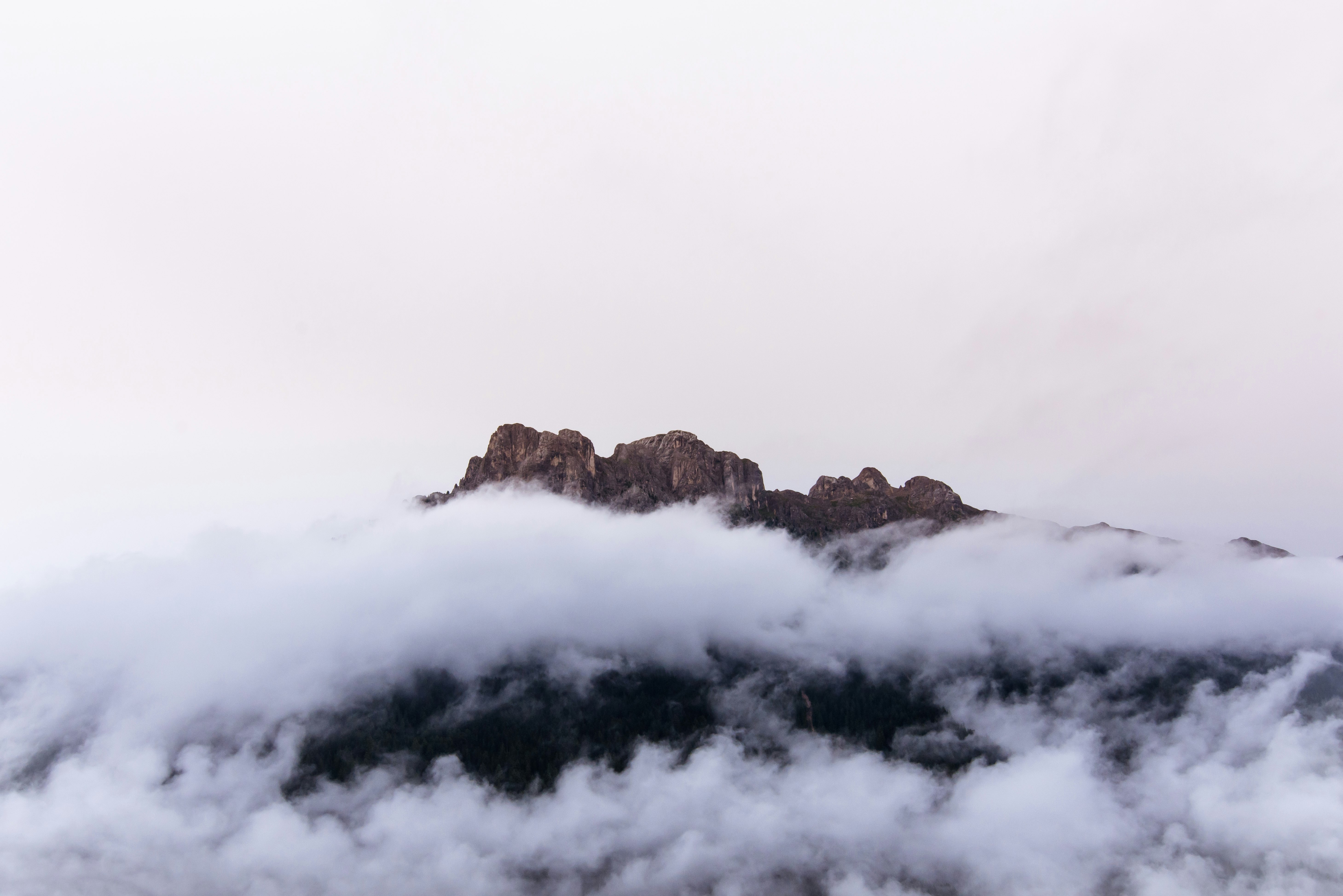 brown rocky mountain covered with clouds